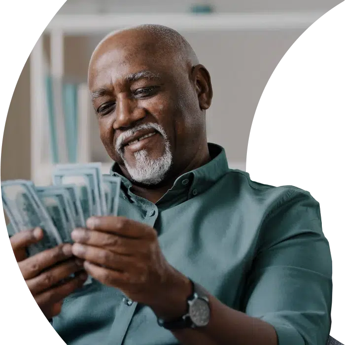 Senior man counting cash with a smile